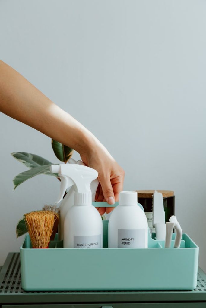 pexels-photo-10557498 Hand arranging cleaning products in a tidy organizer, promoting cleanliness and order.